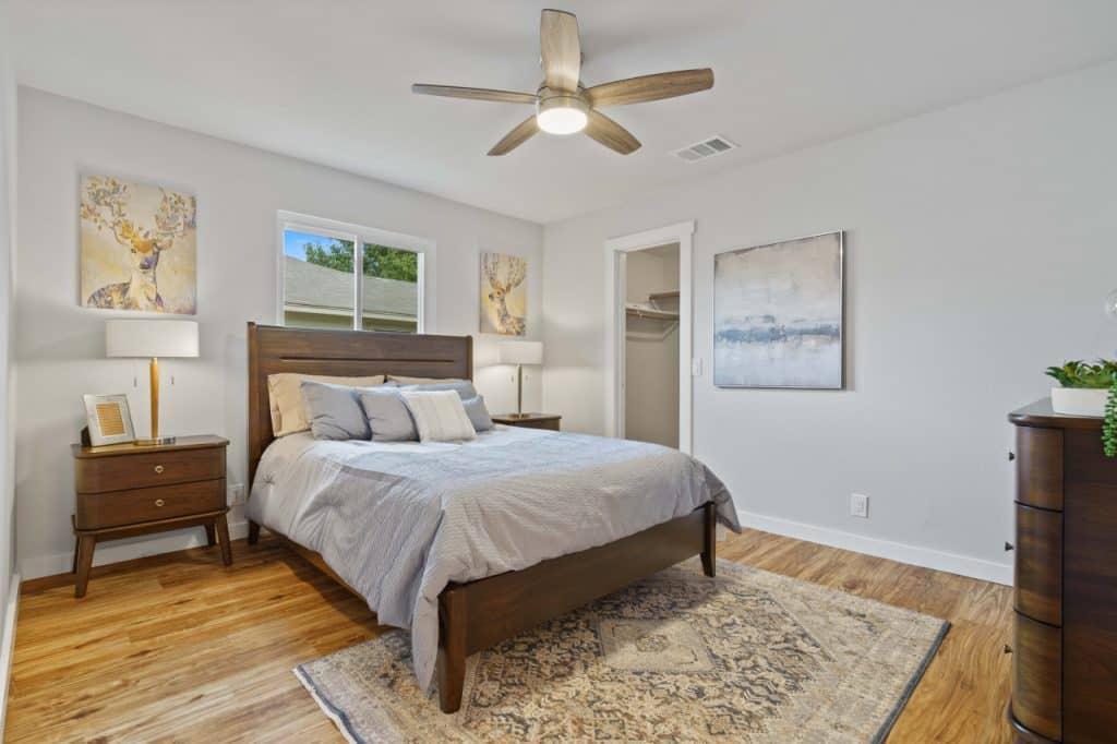 renovated bedroom with ceiling light with fan